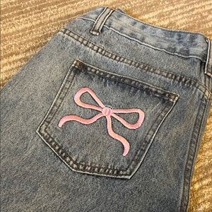 Stylish Blue Jeans with Pink Bow Accent